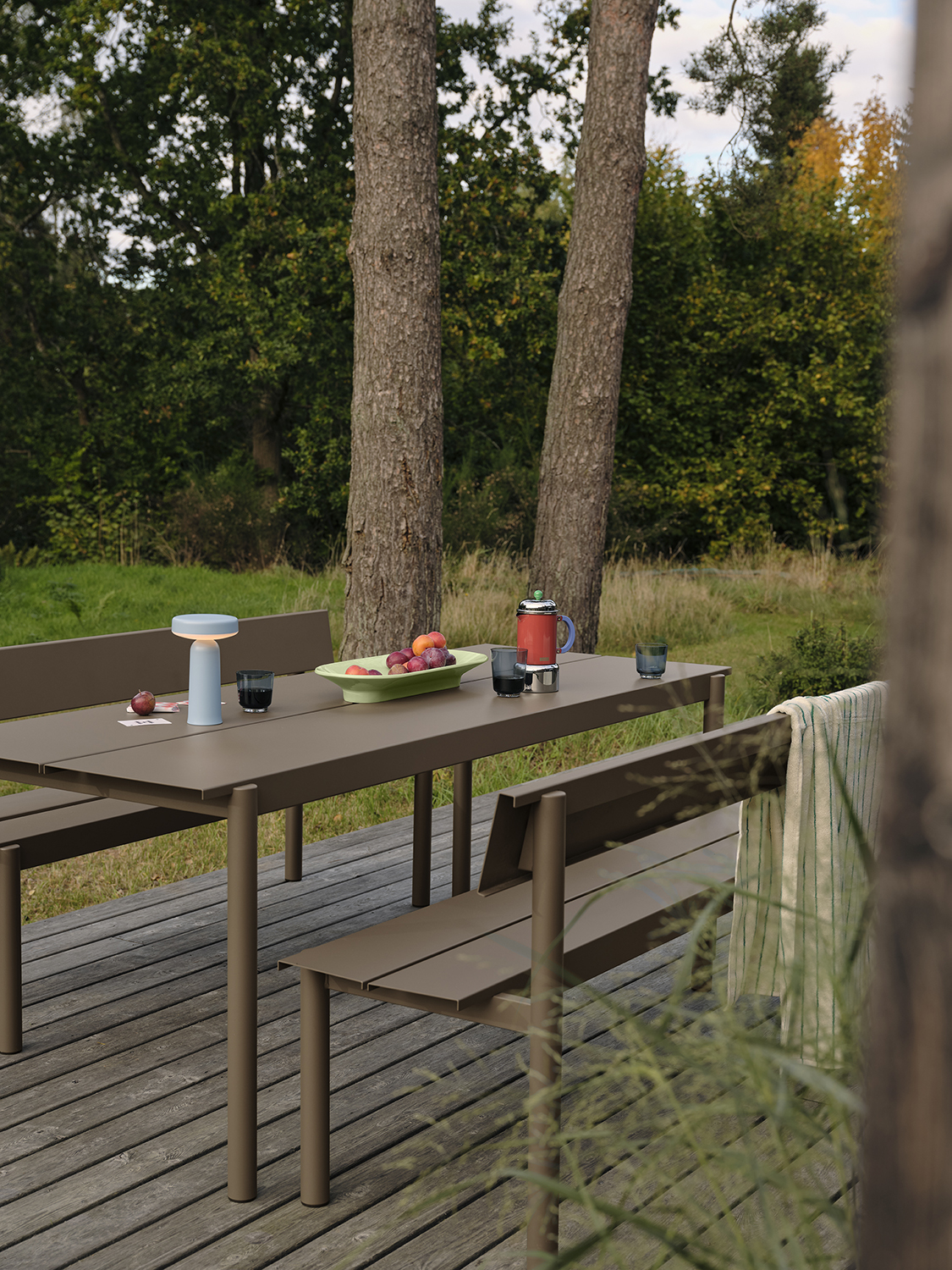 /globalassets/content-media/images/01.-lifestyle-images/january-26/linear-steel-bench-w-backrest-taupe-linear-steel-table-200-taupe-ease-portable-light-blue-mere-raise-low-res.jpg?revision=639114102300000000