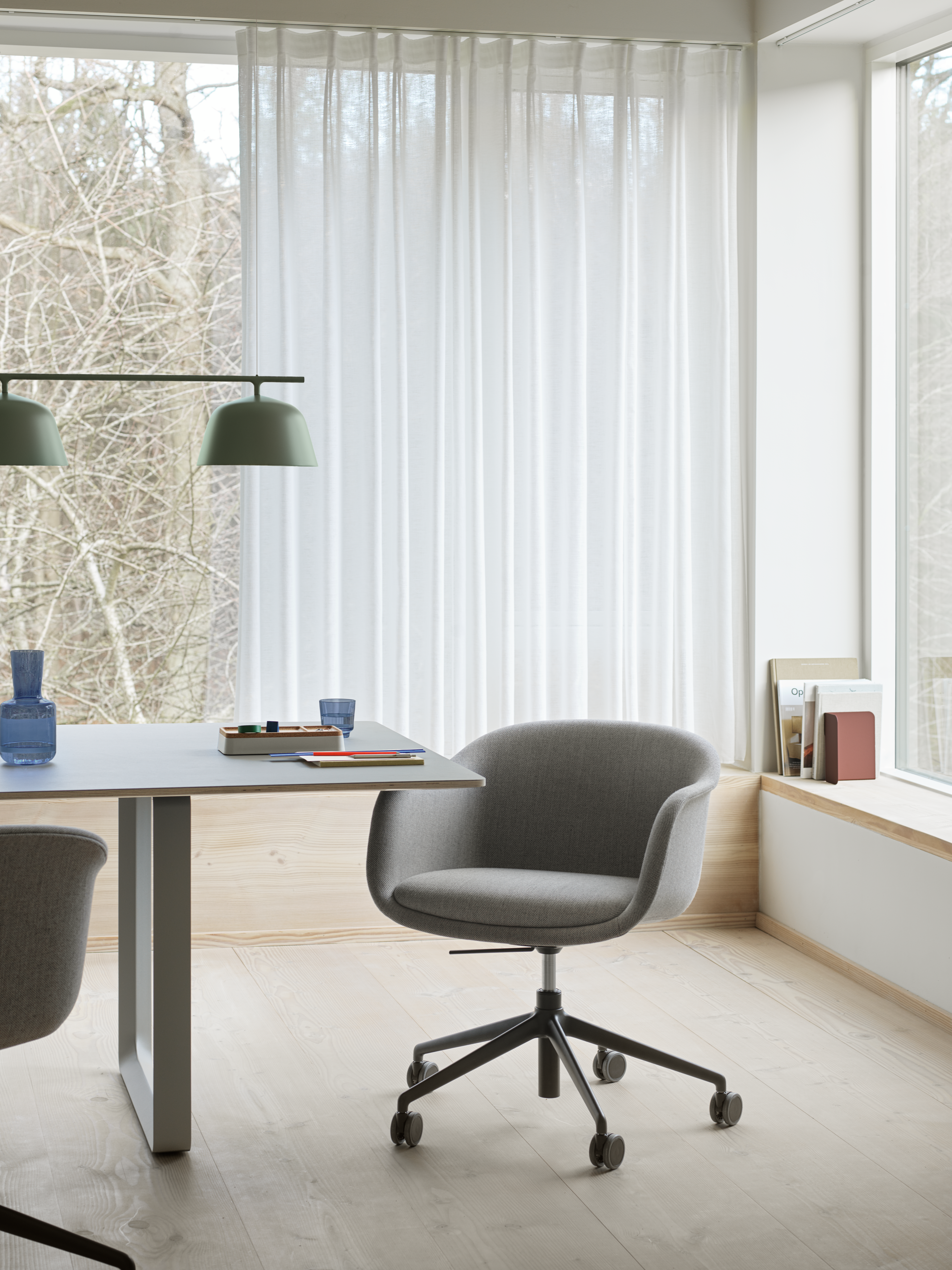 Fiber Conference Armchair - 70/70 Table in Grey - Ambit Rail Lamp in Dusty Green - Raise Carafe & Glasses in Dark Blue - Arrange