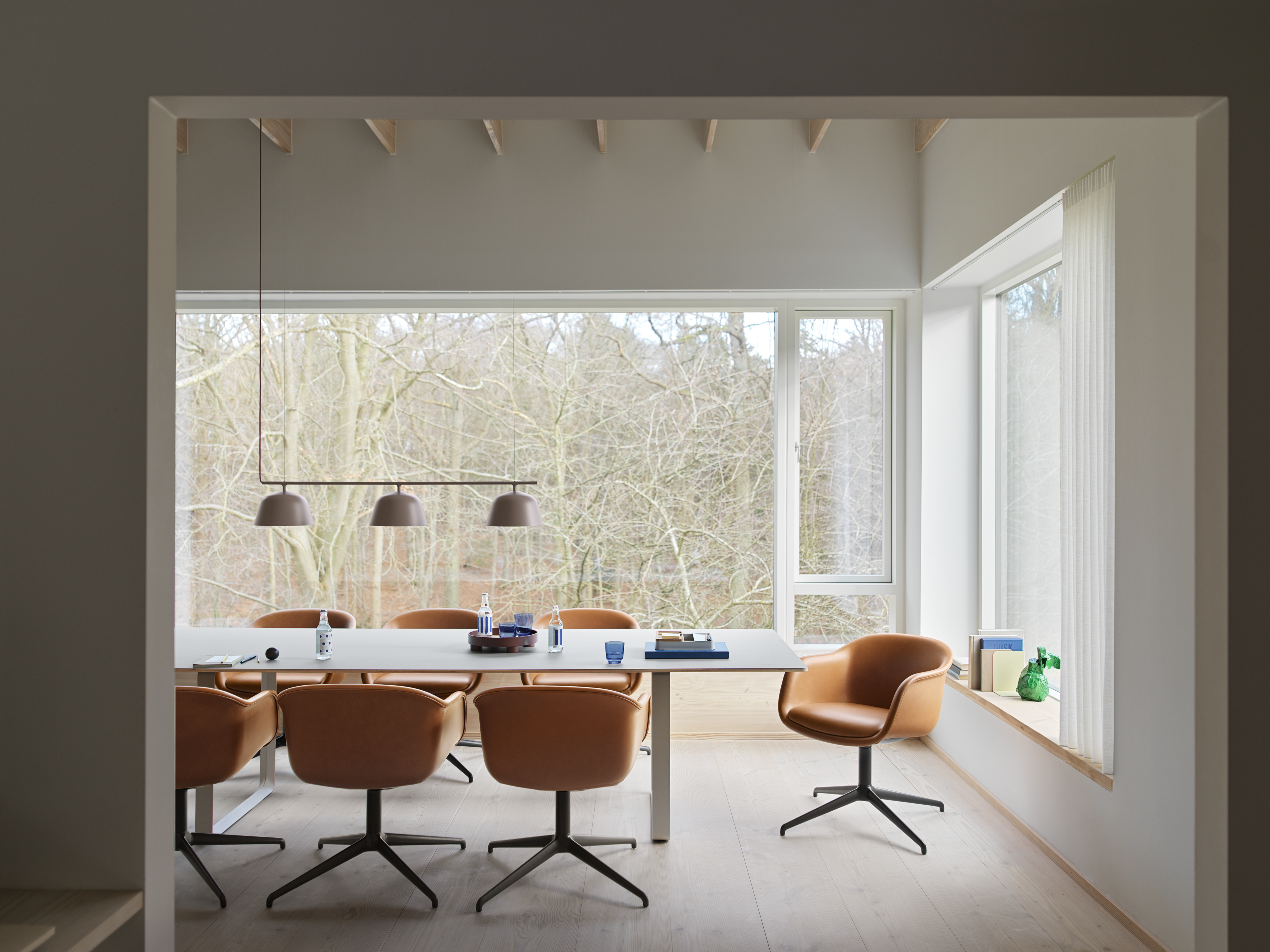 Fiber Conference Armchair w. Swivel Base in Cognac Refine Leather - 70/70 Table in Grey - Ambit Rail Lamp in Taupe - Platform Tray - Raise Glasses in Dark Blue