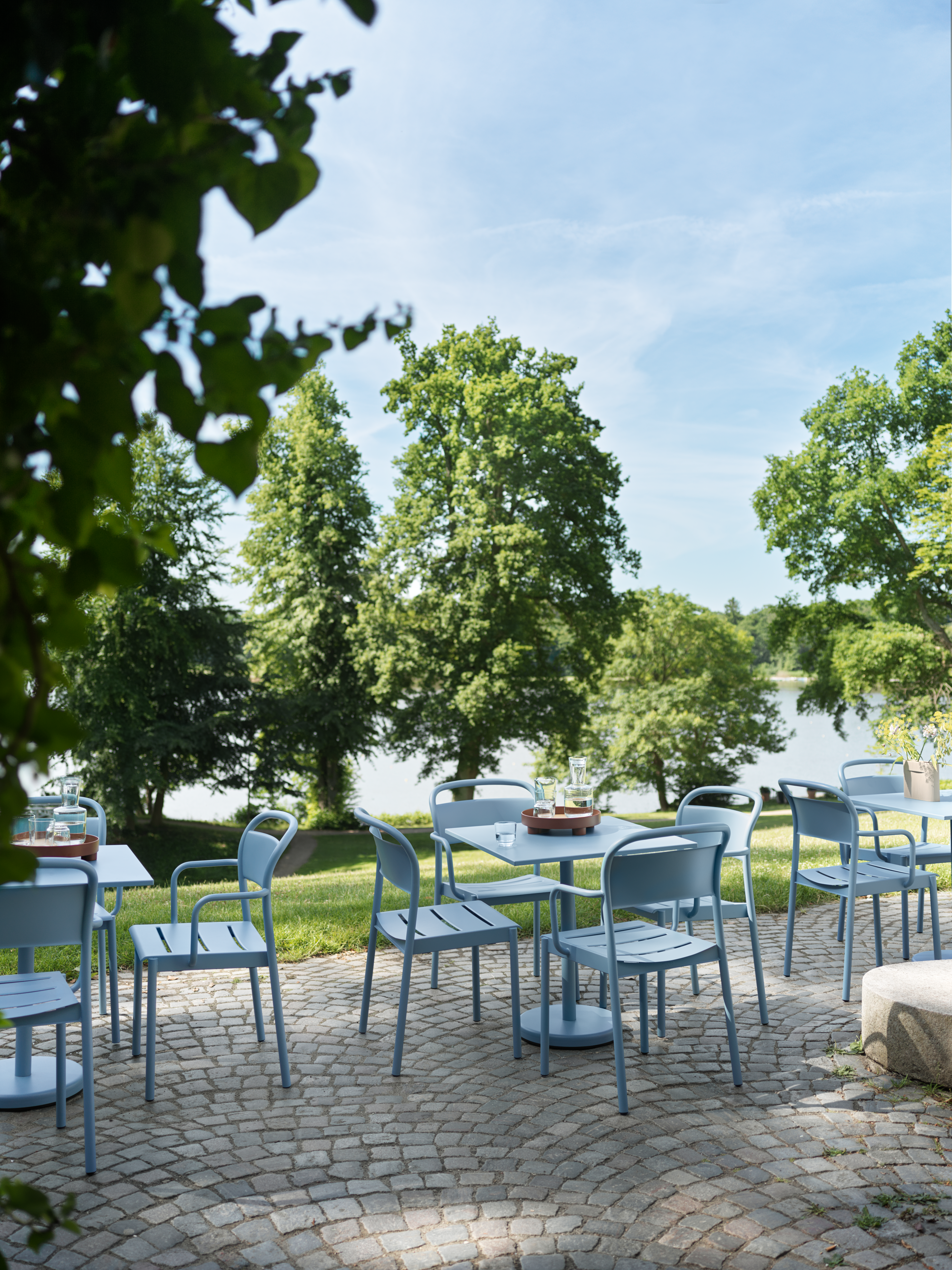 Linear Steel Café Table H:73 cm 70x70 cm in Pale Blue - Linear Steel Side Chair in Pale Blue - Linear Steel Armchair i Pale Blue - Raise Carafe & Glasses in Clear - Platform Tray