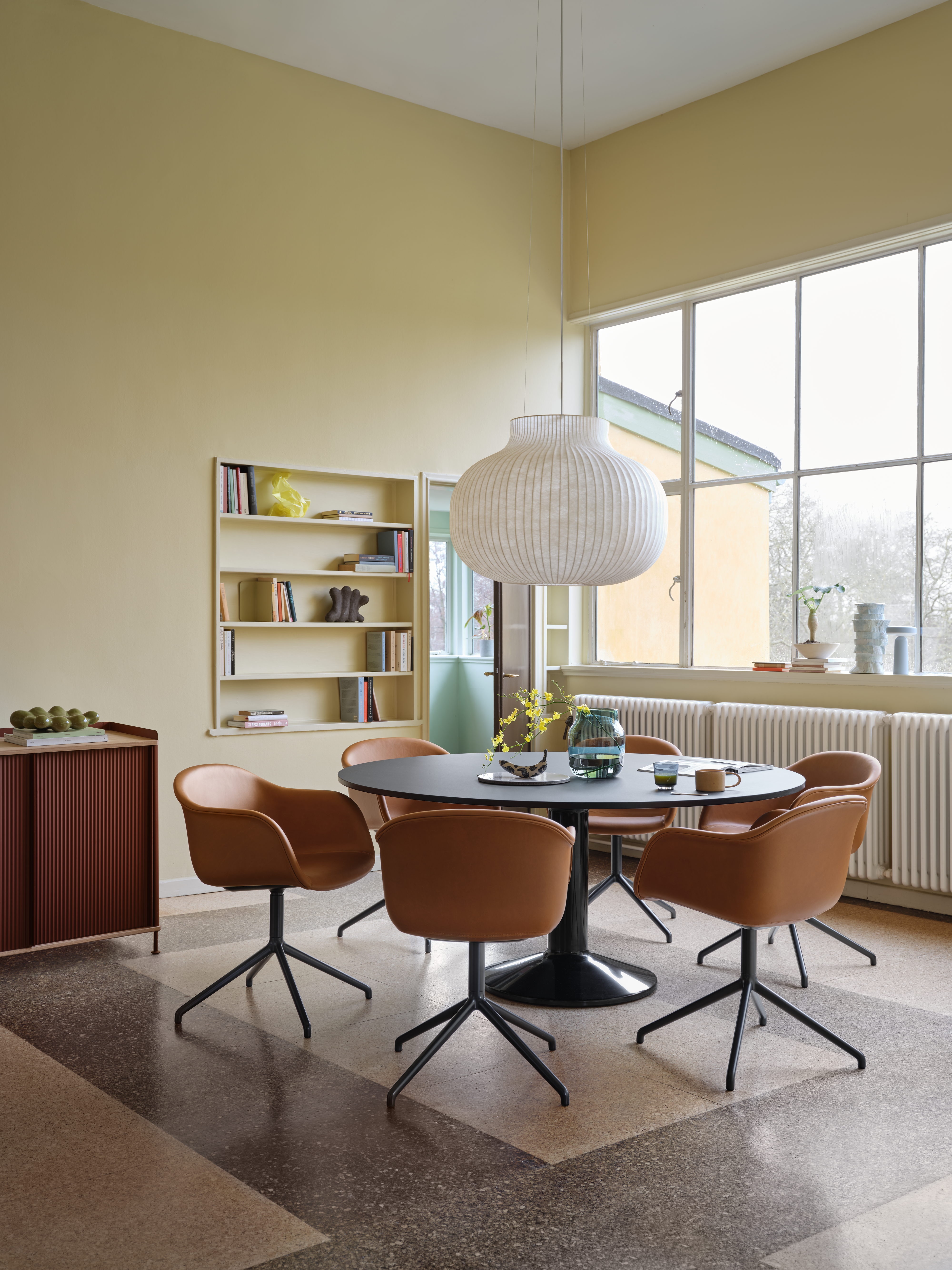 Midst Table &#216;160 cm in Black - Fiber Armchair Swivel Base in Refine Leather Cognac/Black - Silent Vase &#216;20 cm in Dark Green - Enfold Sideboard 148x45 H85 cm in Oak/Deep Red, Strand Pendant Lamp &#216;80 cm in White - Raise Glass in Dark Blue - Ease Portable Lamp in Light Blue