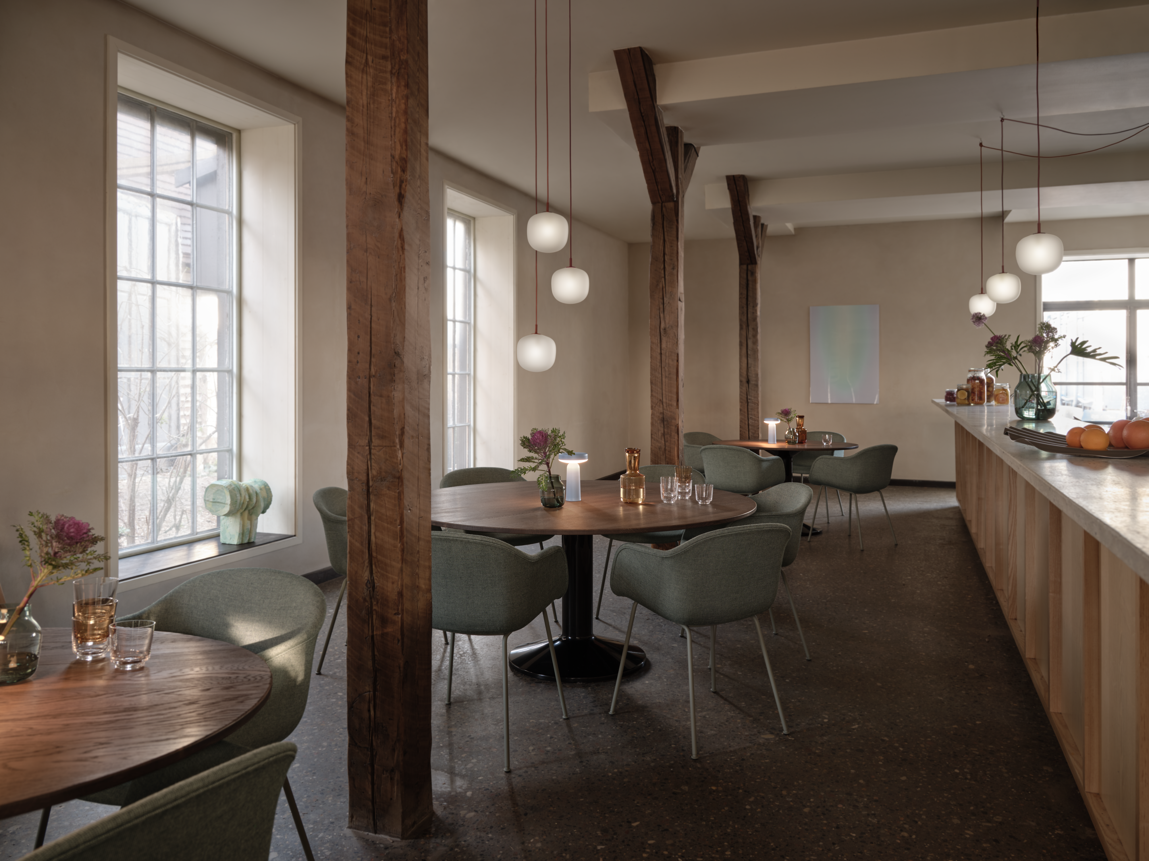 Midst Table &#216;160 cm in Dark Oiled Oak/Black - Fiber Armchair Tube Base Sabi 921/Dusty Green - Rime Pendant Lamp &#216;18 cm in Deep Red - Ease Portable Lamp in Light Blue - Silent Vase &#216;11 &amp; &#216;20 cm in Dark Green - Raise Carafe in Burnt Orange - Raise Glasses in Clear - Wave Tray