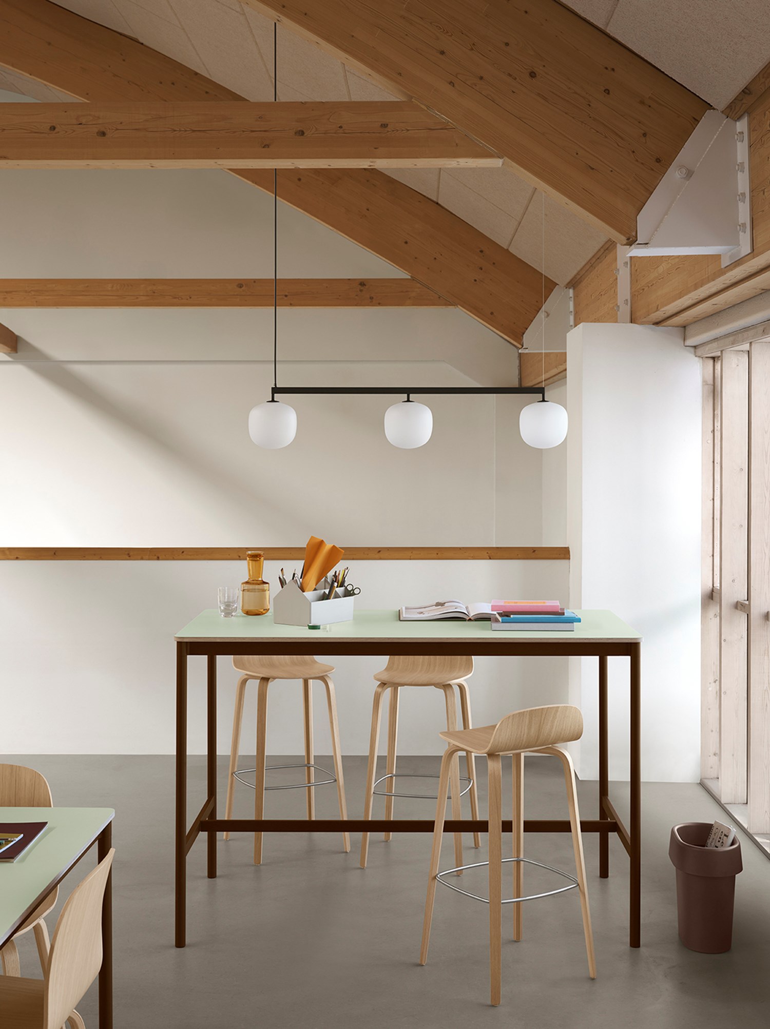 Base High Table in a minimalist setting with wooden high chairs and a rail pendant lamp, showcasing a sleek Nordic style. Base High Table in a minimalist setting with wooden high chairs and a rail pendant lamp, showcasing a sleek Nordic style.