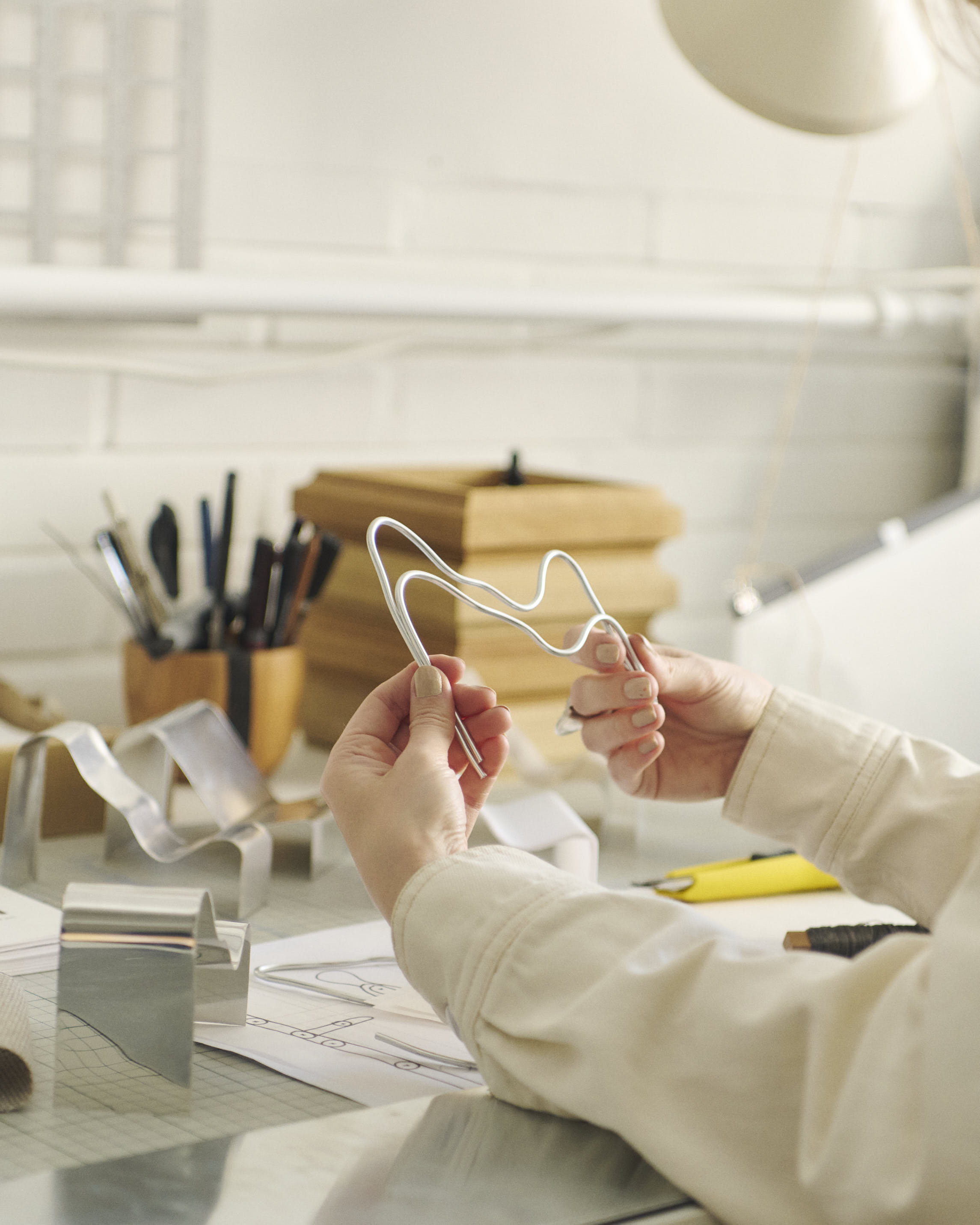 Lise Vester working hands-on in her studio, shaping the Dream View Bench and refining its soft, sculptural form as part of her creative process.