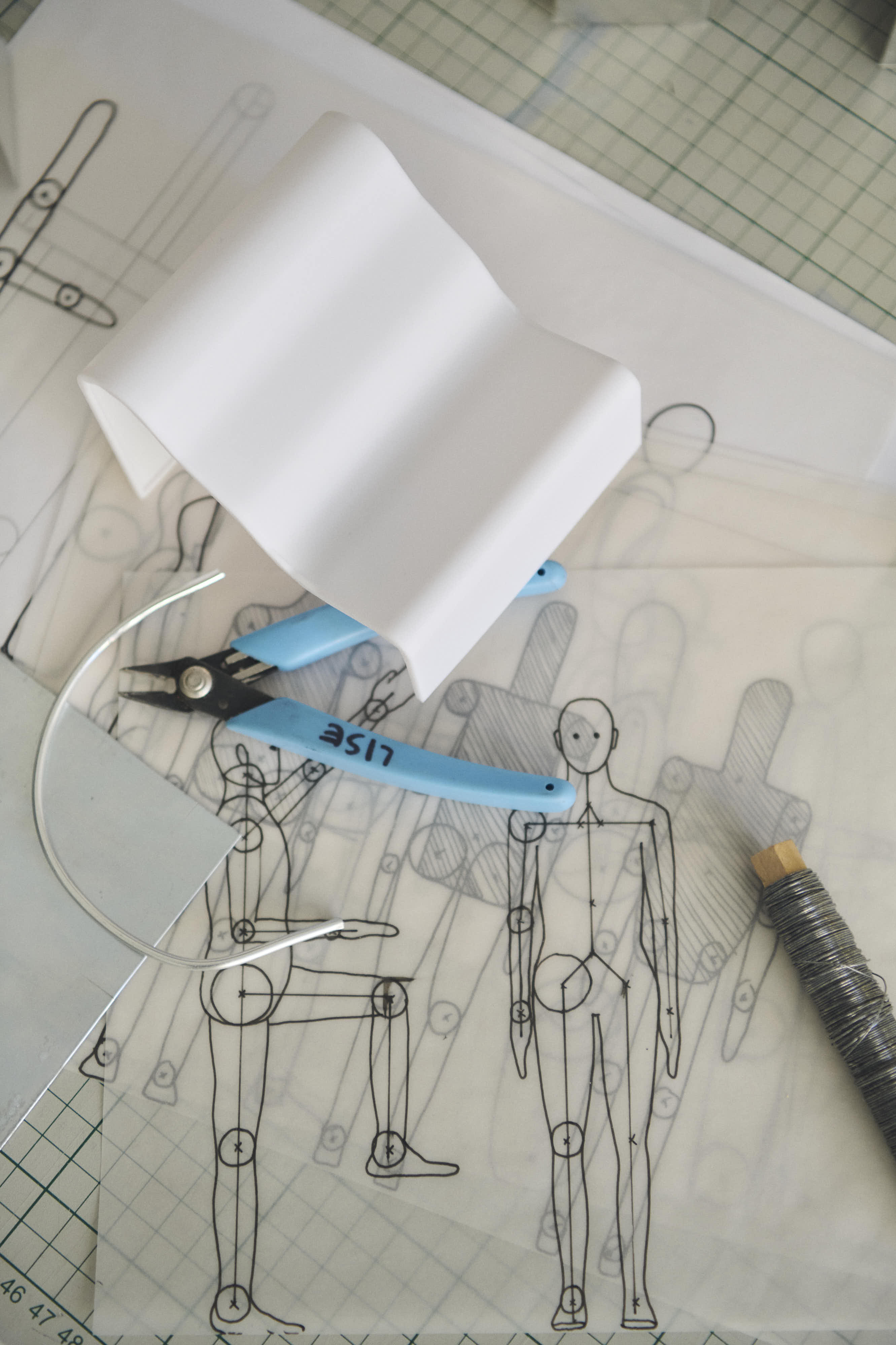 Studio scene showing design materials, tools, and prototypes arranged as part of the creative process, highlighting hands-on experimentation and material development.