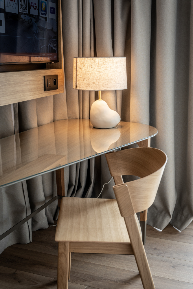 Hotel room in Horizon Resort Massane in France featuring Muuto's Cover Side Chair, creating a modern and welcoming hotel atmosphere.