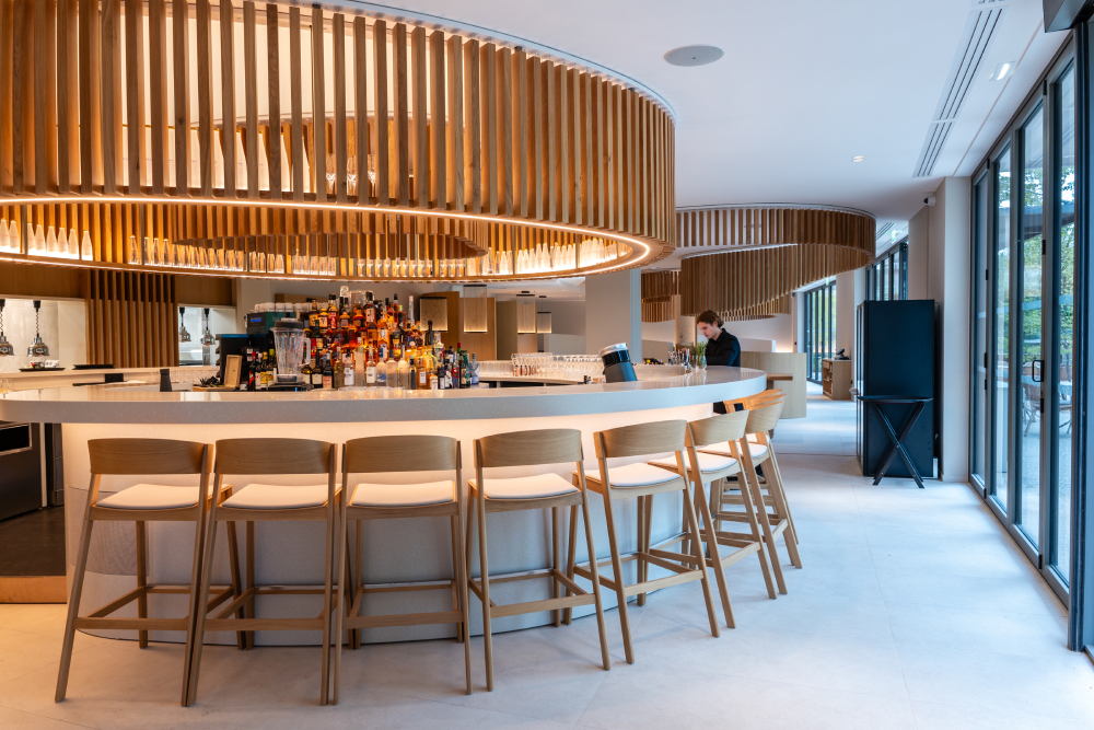 Hotel bar in Horizon Resort Massane in France featuring Muuto's  Cover Bar Stool creating a modern and welcoming hotel atmosphere.