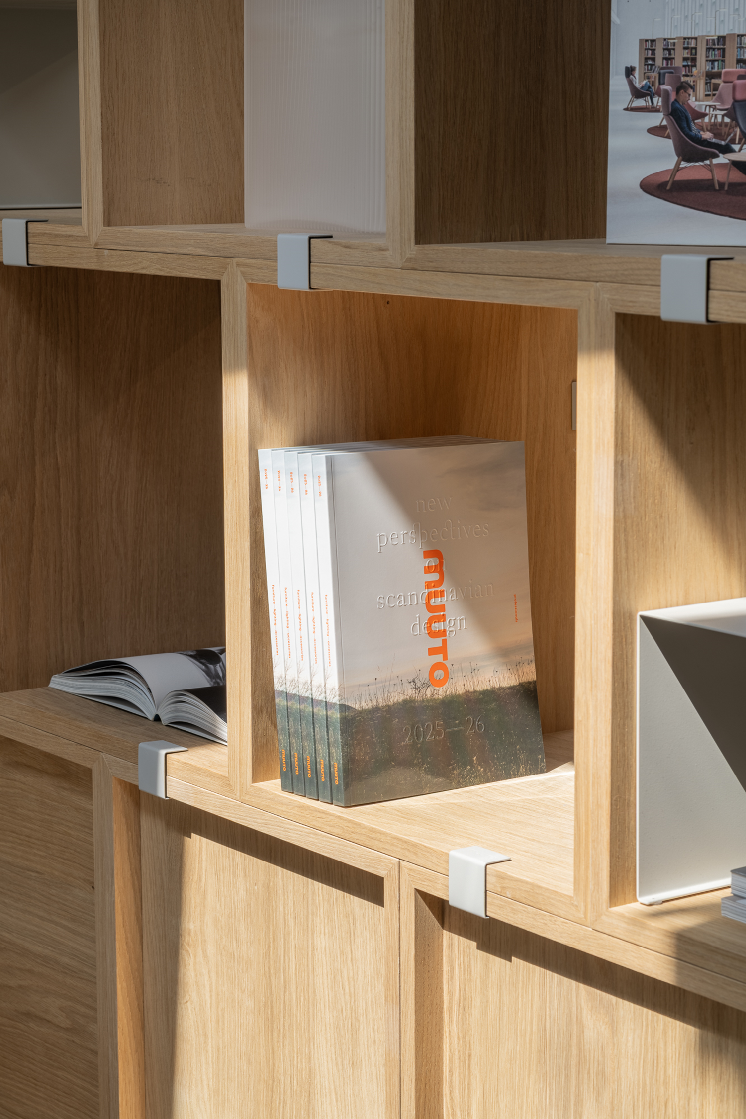 The Muuto Contract Catalog 2025 placed in a bookshelf