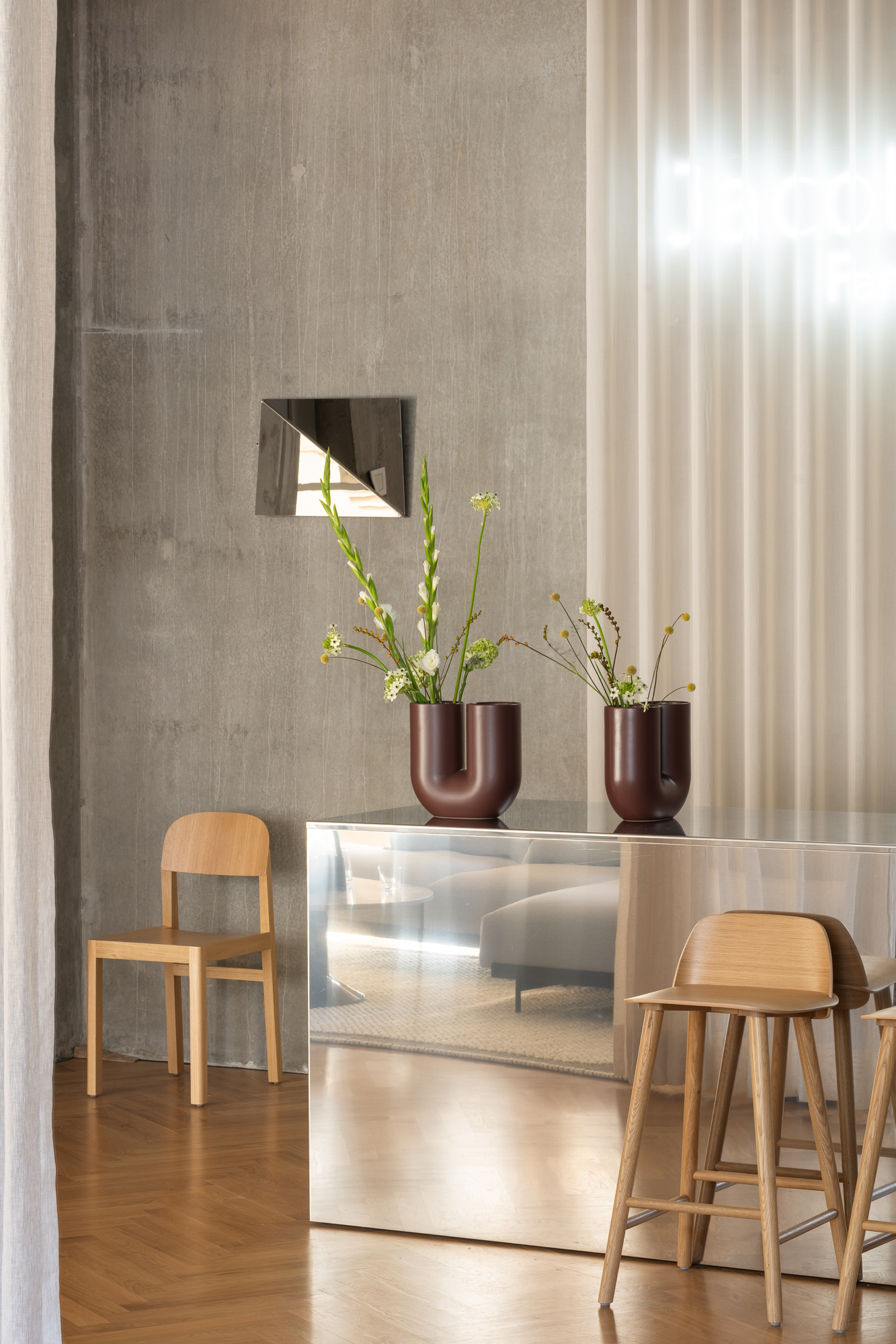 Kink Vase on check-out desk and Gaze Mirror in the background.