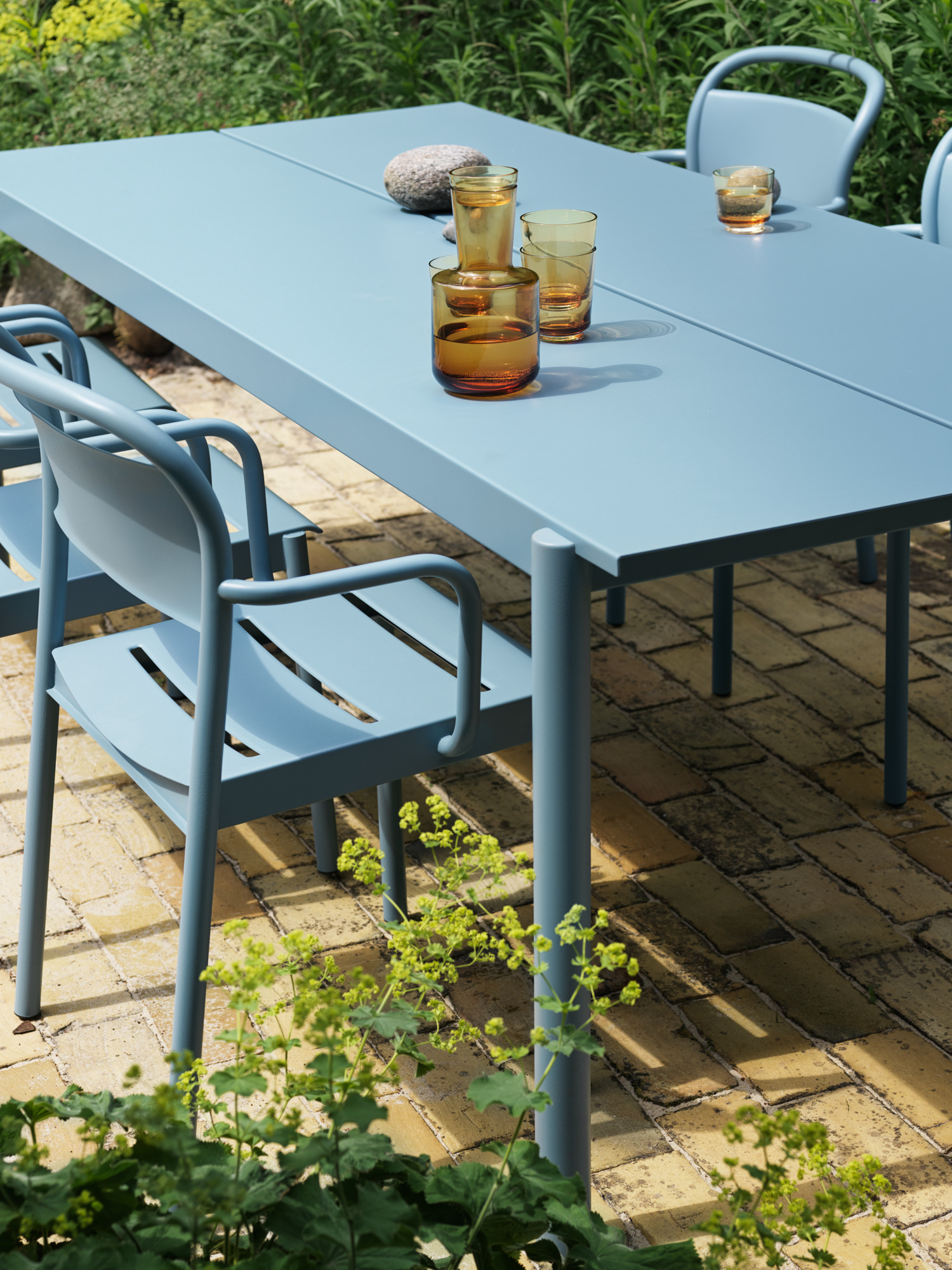 Linear Steel Table 220x90 cm in Pale Blue - Linear Steel Armchair in Pale Blue - Raise Carafe & Glasses in Burnt Orange